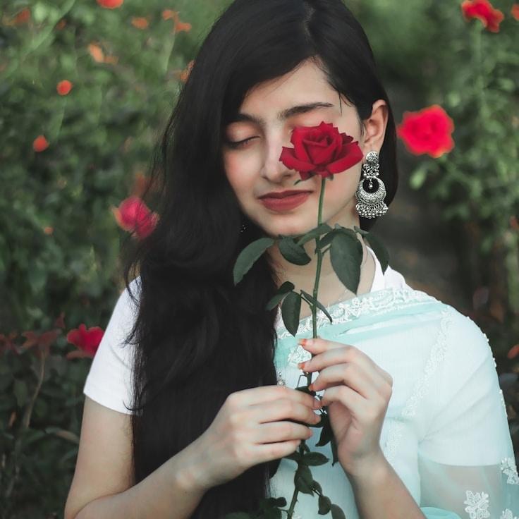 Avery Chen, Lead Design Curator at Season Sunlight Memory, reviewing corporate floral arrangements